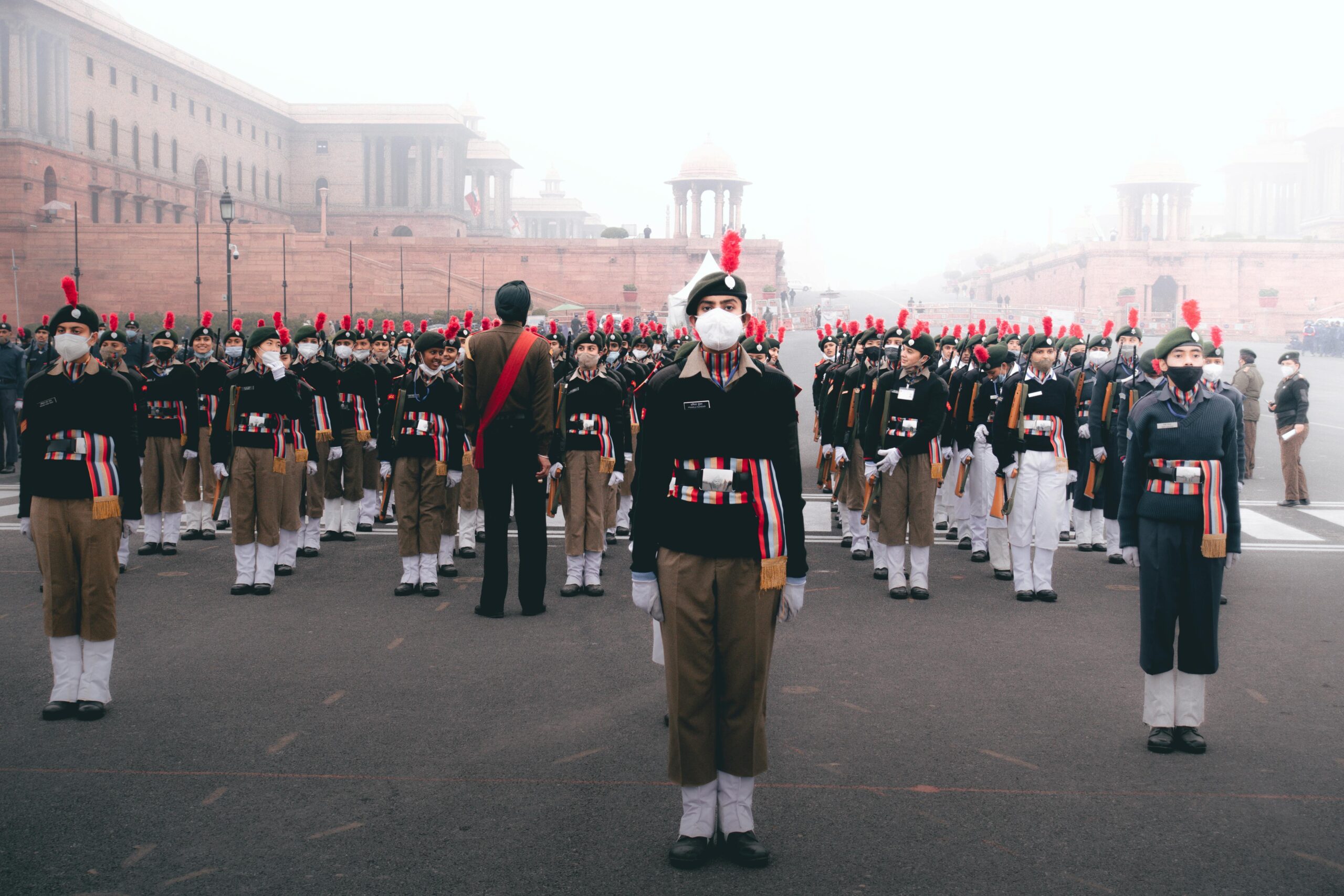 A disciplined military parade showcasing unity and patriotism against a historic backdrop.
